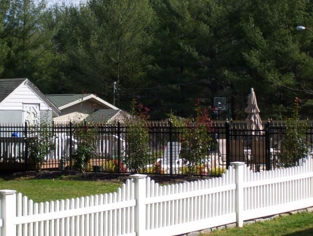 54" High Black Pool Code Aluminum Fence (background)
3' High White Vinyl Stepped Top Picket Fence (foreground)
  